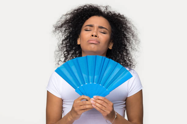 A woman using a paper fan