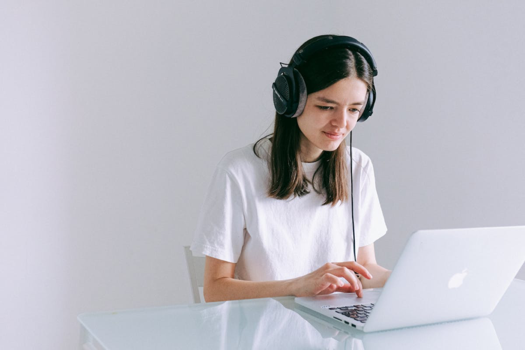 a woman with headphones using a laptop